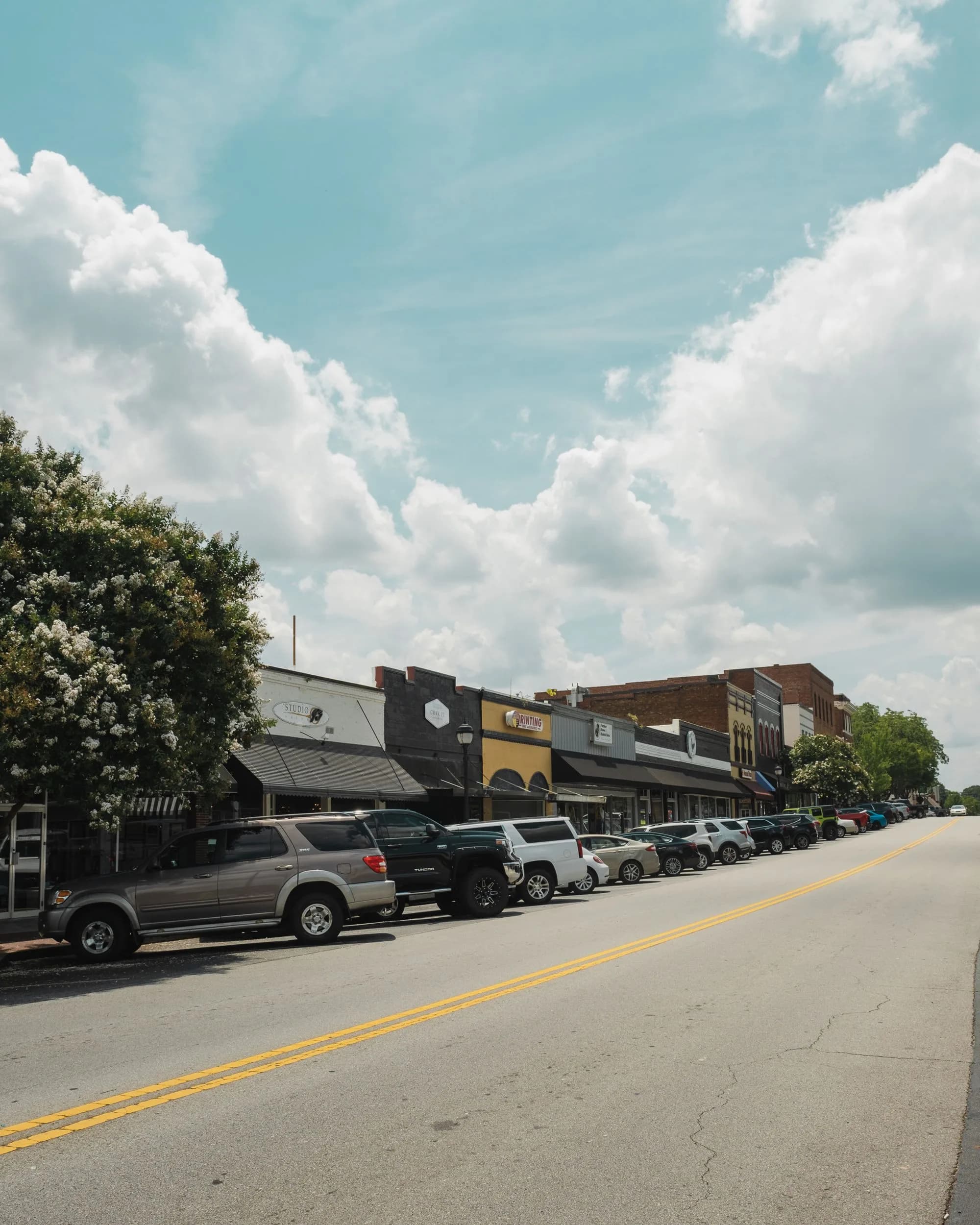 A Southern small-town main street of brick storefronts with awnings